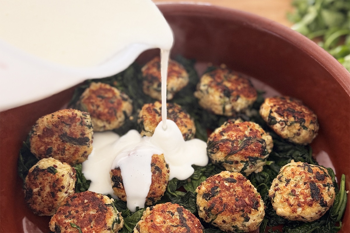 Boulettes de poulet au quinoa, épinards et béchamel légère gratinées dans un plat sain et équilibré, servies pour un dîner healthy sous 500 kcal.